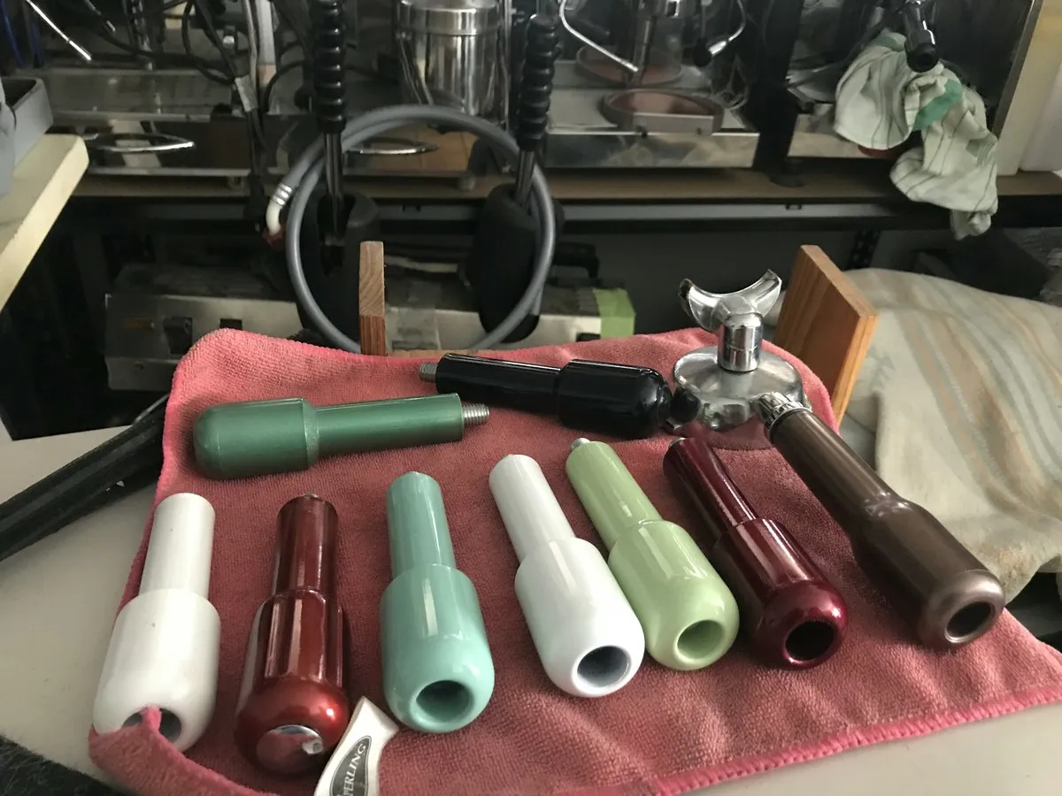 Portafilter handles laid out on a towel