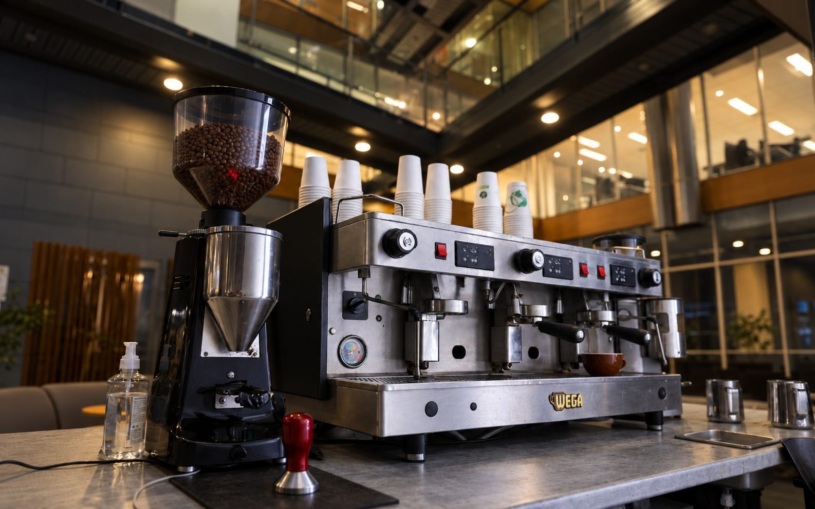 Three-group espresso machine and grinder in a bright atrium